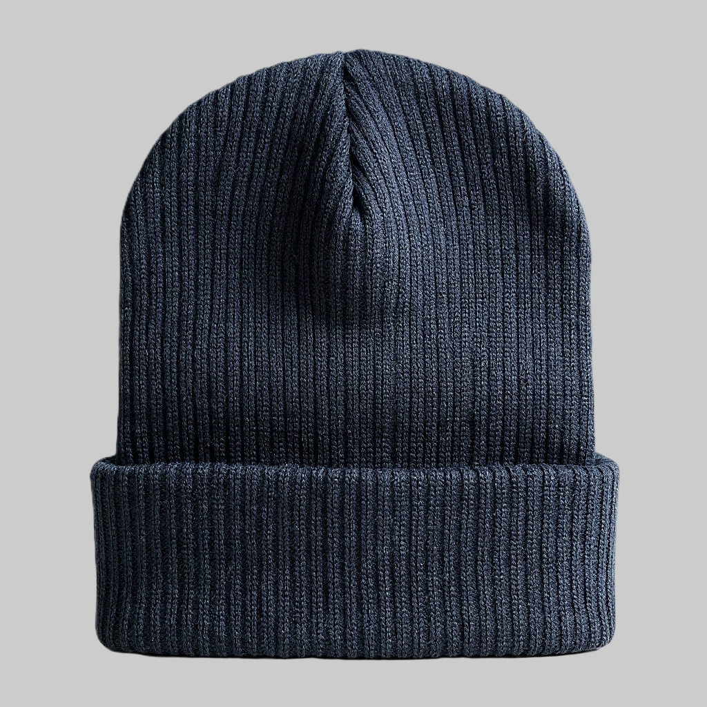 Dark blue knit beanie on a gray background